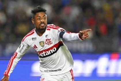 Atacante do Flamengo de uniforme branco comemora gol apontando para a torcida, antes de Flamengo x Del Valle pela Libertadores